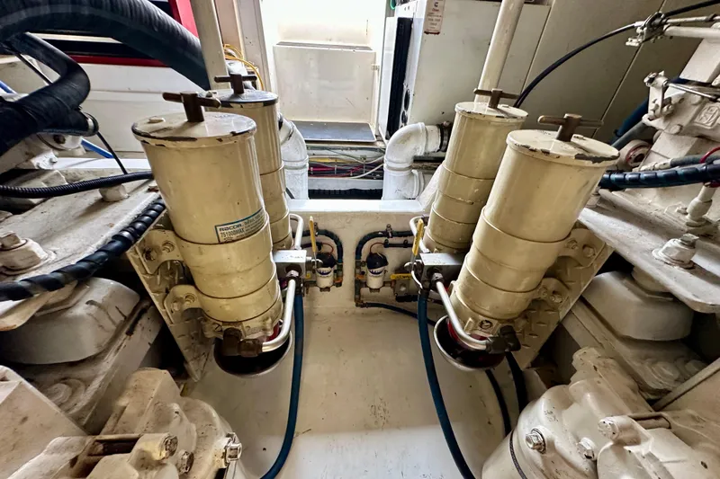 Dock Fee Yacht Photos Pics Engine room of a 1998 Viking 50 Convertible yacht, showcasing mechanical components.