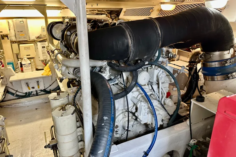 Dock Fee Yacht Photos Pics Engine room of a 1998 Viking 50 Convertible yacht, showcasing machinery and components.