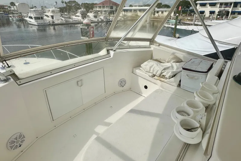 Dock Fee Yacht Photos Pics 1998 Viking 50 Convertible yacht interior with seating, storage, and marina view.