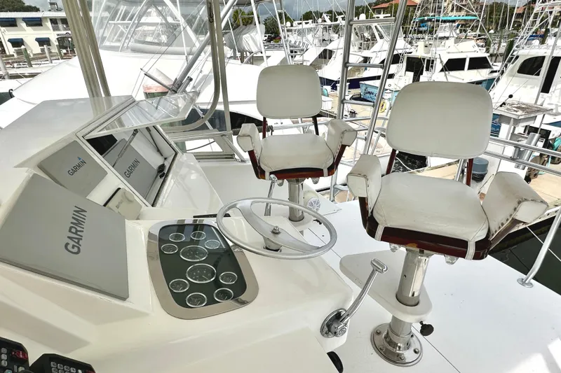 Dock Fee Yacht Photos Pics Cockpit of 1998 Viking 50 Convertible yacht with Garmin navigation system and dual captain chairs.