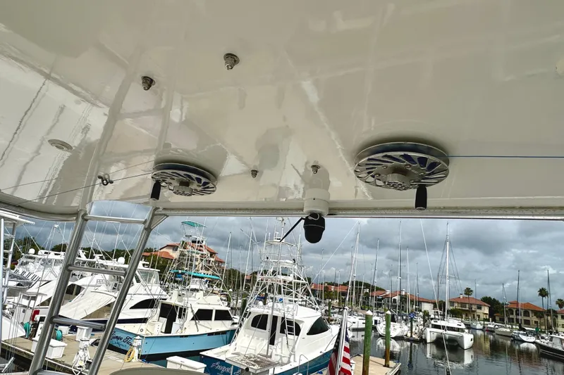 Dock Fee Yacht Photos Pics 1998 Viking 50 Convertible yacht with marina view, featuring speakers and overcast sky.