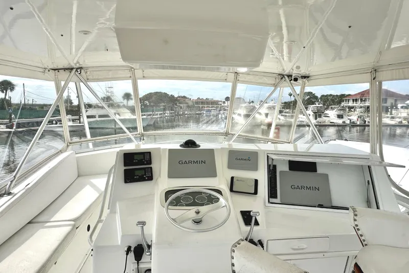 Dock Fee Yacht Photos Pics 1998 Viking 50 Convertible yacht helm with Garmin navigation, docked at marina.