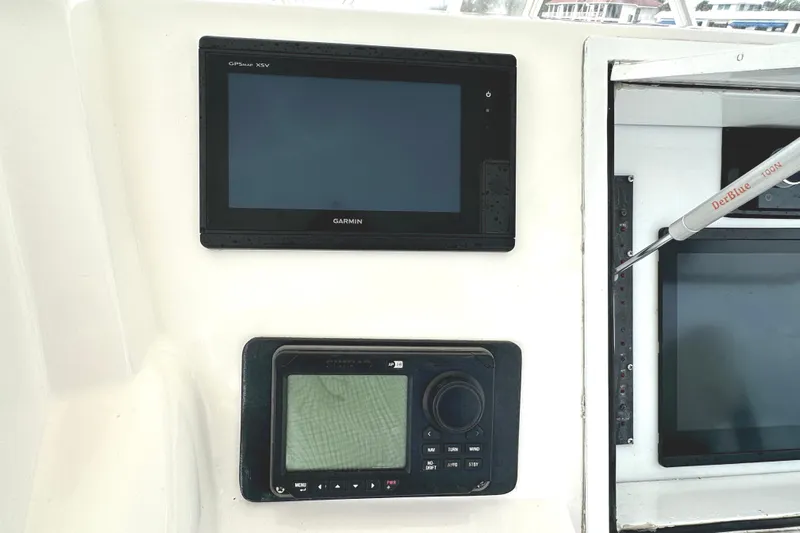 Dock Fee Yacht Photos Pics Garmin and Simrad navigation displays on 1998 Viking 50 Convertible yacht dashboard.