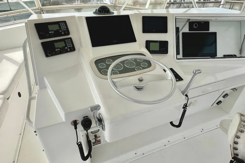 Dock Fee Yacht Photos Pics Cockpit of 1998 Viking 50 Convertible yacht with steering wheel and navigation controls.
