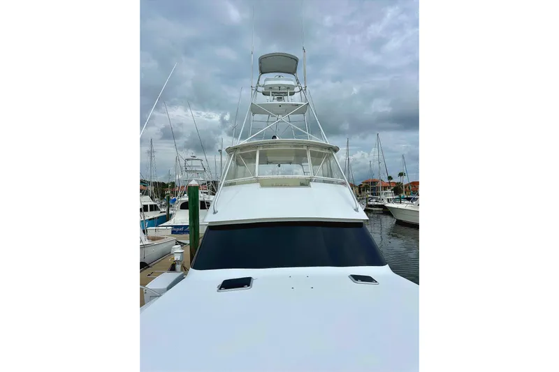 Dock Fee Yacht Photos Pics 1998 Viking 50 Convertible yacht docked at marina under cloudy skies.
