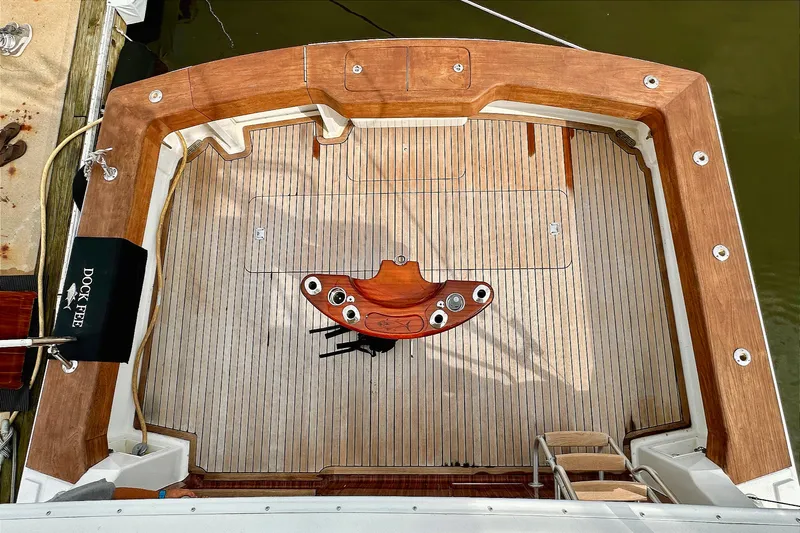 Dock Fee Yacht Photos Pics 1998 Viking 50 Convertible yacht deck with wooden flooring and fishing rod holders.