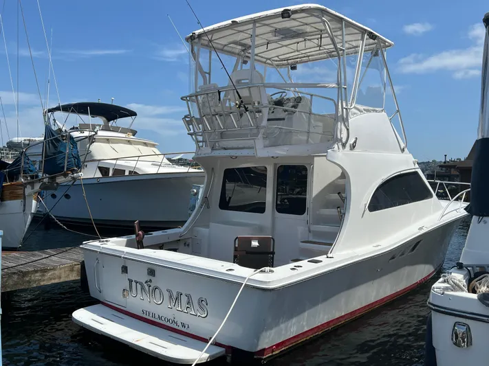 Uno Mas Yacht Photos Pics 2001 Luhrs 360 Convertible yacht docked at marina under clear blue sky.