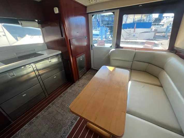 Uno Mas Yacht Photos Pics Interior of 2001 Luhrs 360 Convertible yacht with dining area and kitchenette.