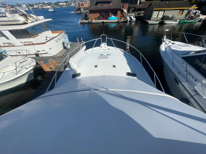 Uno Mas Yacht Photos Pics 2001 Luhrs 360 Convertible yacht docked, surrounded by water and neighboring boats.