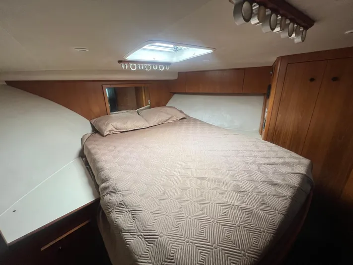 Uno Mas Yacht Photos Pics 2001 Luhrs 360 Convertible cabin with bed, wood paneling, and overhead lighting.