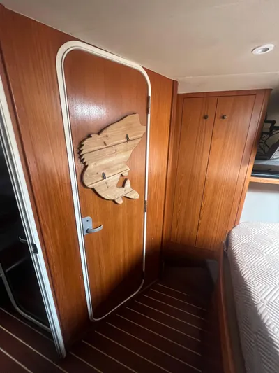 Uno Mas Yacht Photos Pics 2001 Luhrs 360 Convertible cabin interior with wooden door and fish-shaped decor.