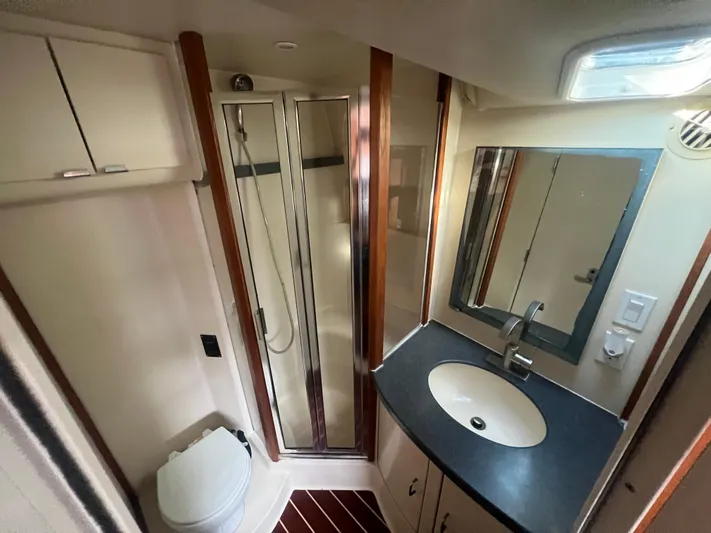 Uno Mas Yacht Photos Pics 2001 Luhrs 360 Convertible yacht bathroom with shower, sink, and toilet.