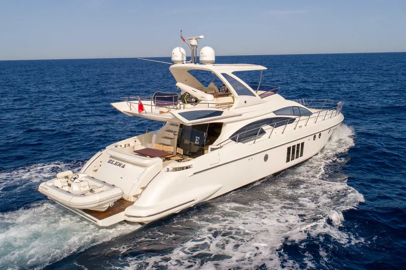 Elena Yacht Photos Pics Luxury 2013 Azimut 64 yacht cruising on open sea, rear view.