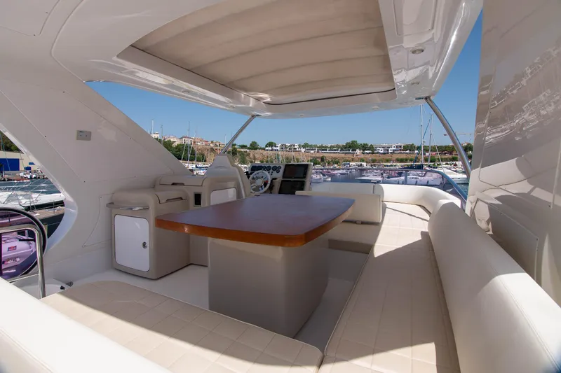 Elena Yacht Photos Pics Luxurious 2013 Azimut 64 yacht interior with elegant seating and wooden table.
