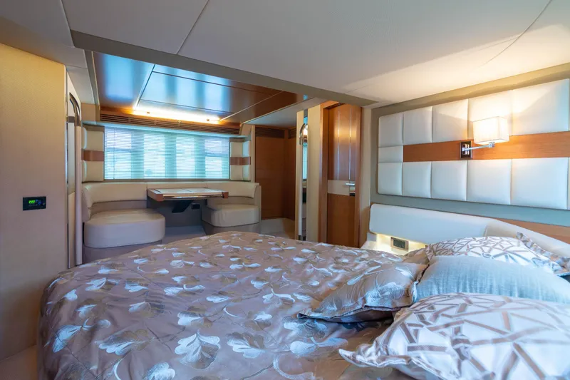 Elena Yacht Photos Pics Luxurious bedroom interior of a 2013 Azimut 64 yacht with elegant decor and seating area.