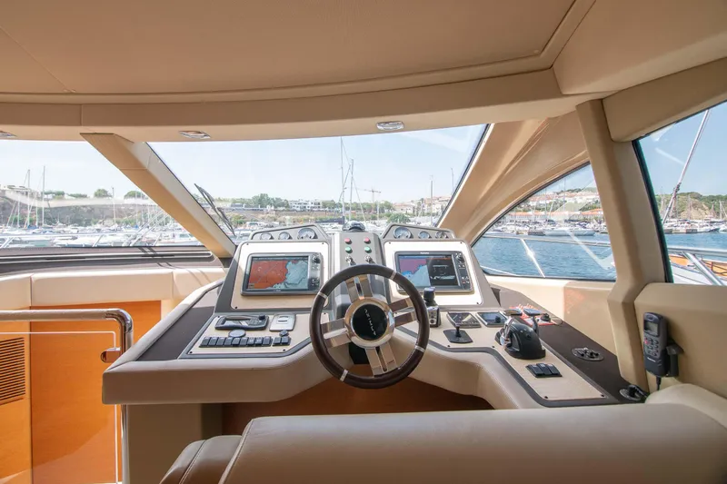 Elena Yacht Photos Pics Cockpit view of 2013 Azimut 64 yacht with modern navigation equipment and scenic marina backdrop.