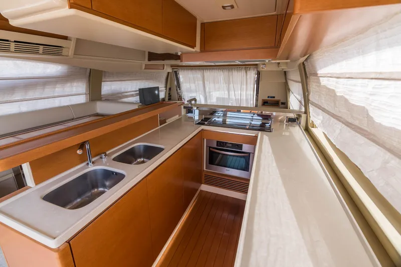 Elena Yacht Photos Pics Luxurious kitchen interior of 2013 Azimut 64 yacht with modern amenities and sleek design.