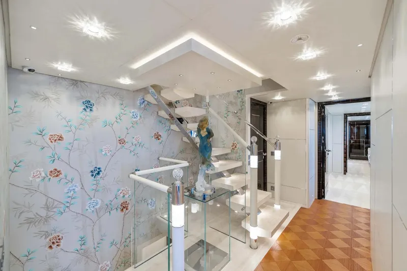  Yacht Photos Pics Luxurious interior of 2018 Sanlorenzo 52Steel yacht with elegant staircase and floral wallpaper.