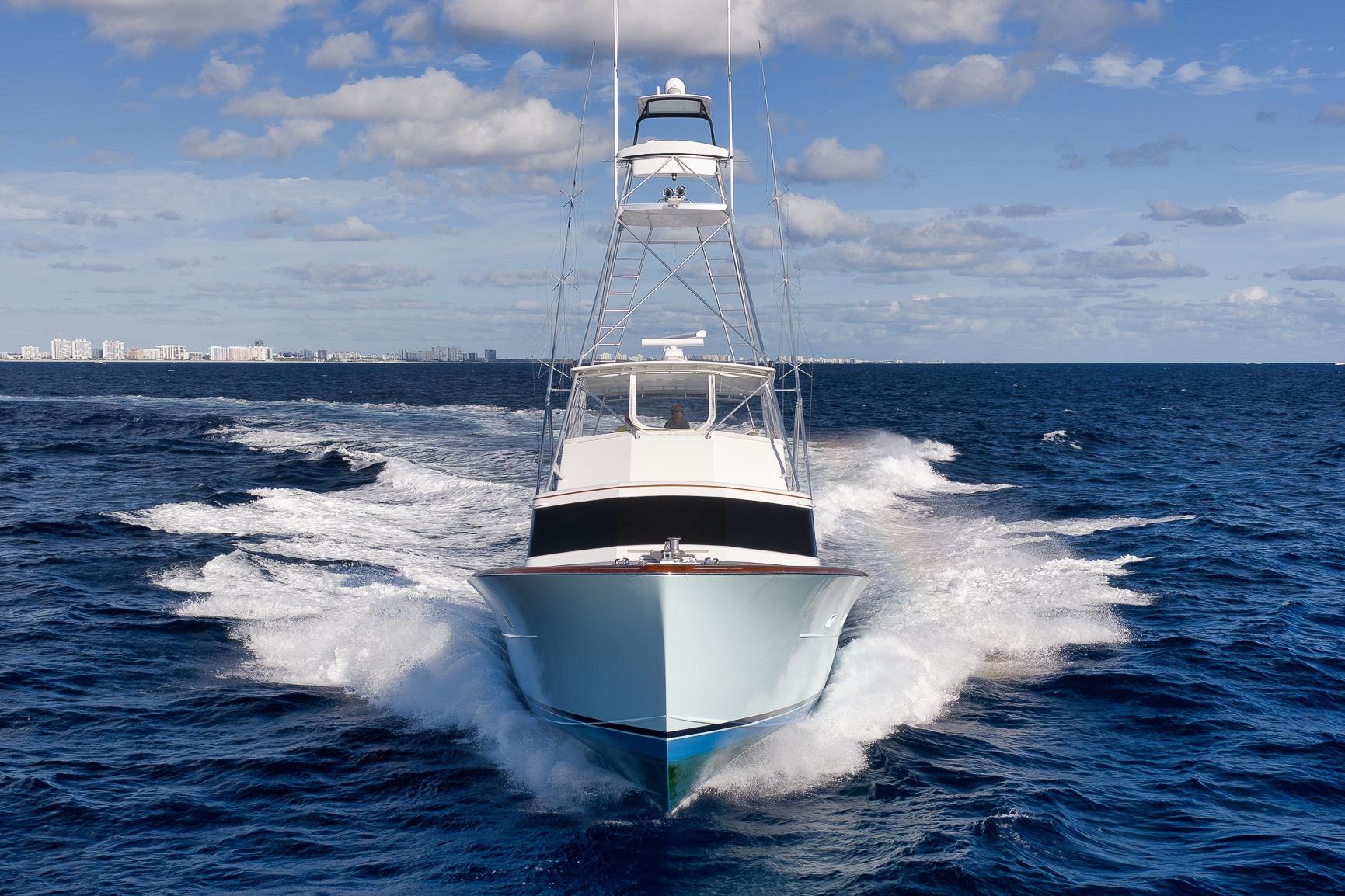 1993 Merritt Sportfish yacht cruising on open ocean under blue sky.