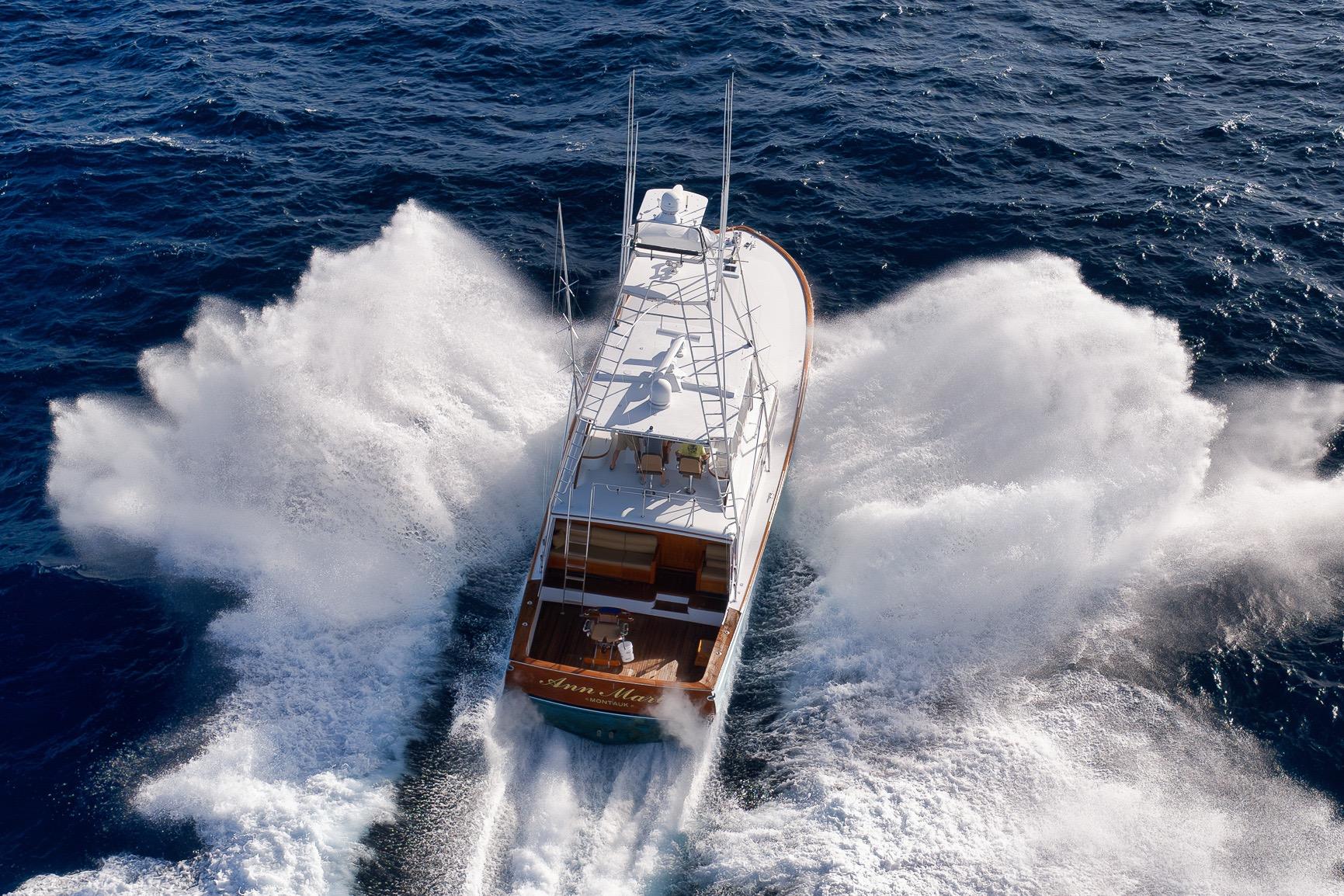 1993 Merritt Sportfish yacht cruising through ocean waves, aerial view.