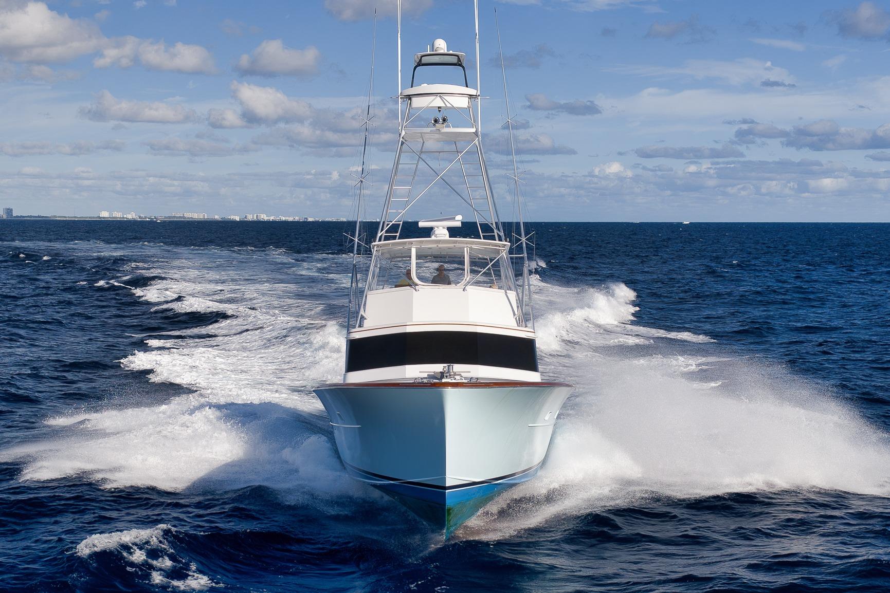 1993 Merritt Sportfish yacht cruising on open ocean under blue sky.