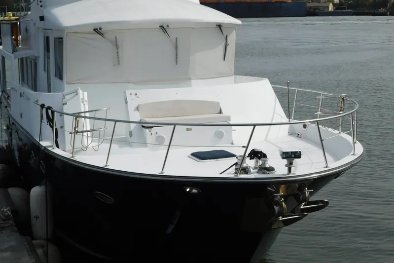 Liquid Gold Yacht Photos Pics 2001 Jefferson Pilothouse 57 yacht docked, featuring spacious deck and sleek design.