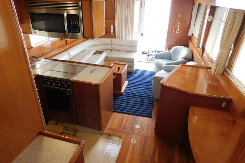 Liquid Gold Yacht Photos Pics Luxurious interior of 2001 Jefferson Pilothouse 57 yacht with modern kitchen and seating area.