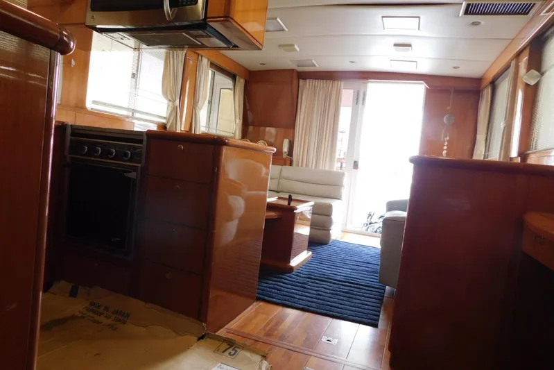 Liquid Gold Yacht Photos Pics Luxurious interior of 2001 Jefferson Pilothouse 57 yacht with wood finishes and modern amenities.