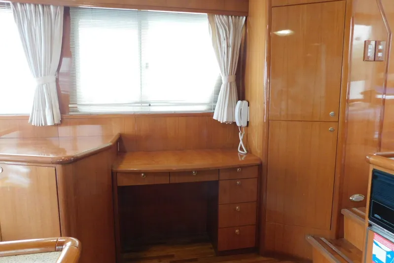 Liquid Gold Yacht Photos Pics Interior of 2001 Jefferson Pilothouse 57 yacht with wooden desk and cabinetry.