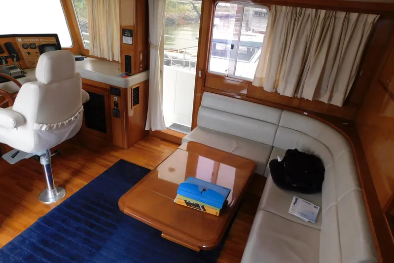 Liquid Gold Yacht Photos Pics Interior of 2001 Jefferson Pilothouse 57 yacht with seating area and helm.
