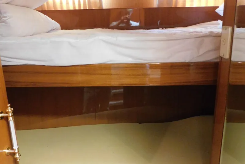 Liquid Gold Yacht Photos Pics Interior of 2001 Jefferson Pilothouse 57 yacht, featuring a wooden bunk bed.