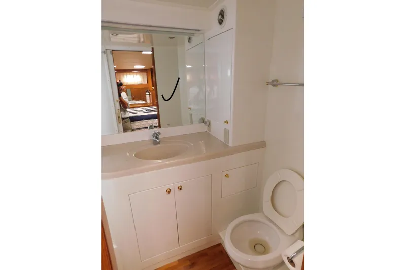 Liquid Gold Yacht Photos Pics Bathroom interior of 2001 Jefferson Pilothouse 57 yacht with sink and toilet.
