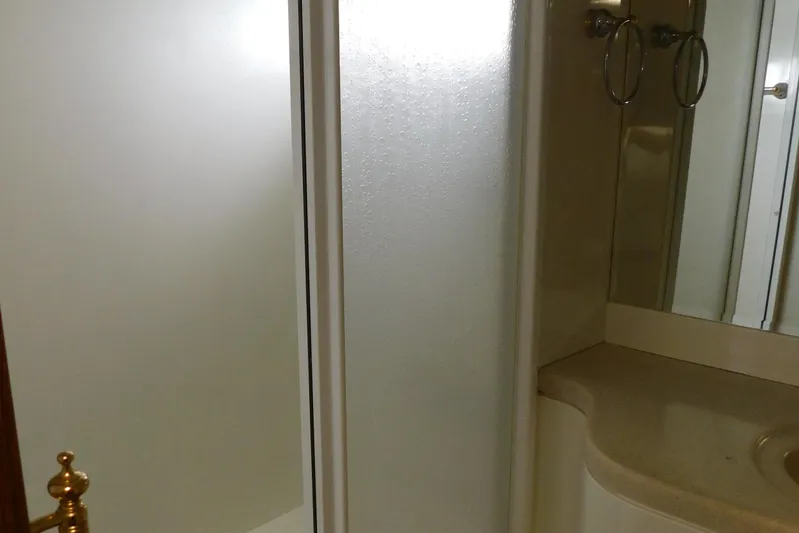Liquid Gold Yacht Photos Pics Bathroom interior of 2001 Jefferson Pilothouse 57 yacht, featuring shower and vanity.