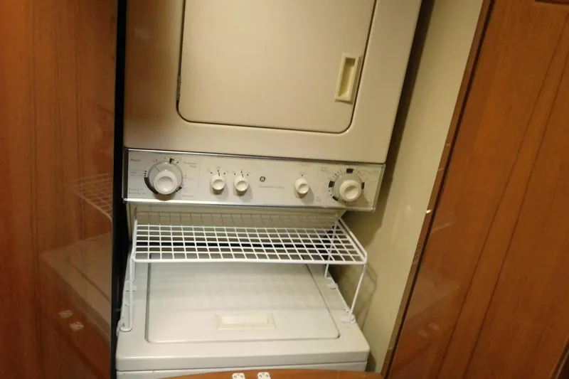Liquid Gold Yacht Photos Pics Stacked washer and dryer in a 2001 Jefferson Pilothouse 57 yacht interior.