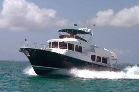 Liquid Gold Yacht Photos Pics 2001 Jefferson Pilothouse 57 yacht cruising on open water under a clear sky.