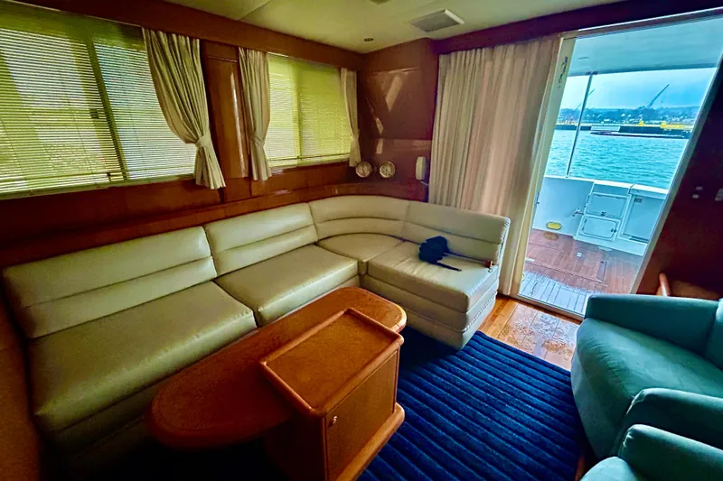 Liquid Gold Yacht Photos Pics Luxurious interior of 2001 Jefferson Pilothouse 57 yacht with leather seating and ocean view.