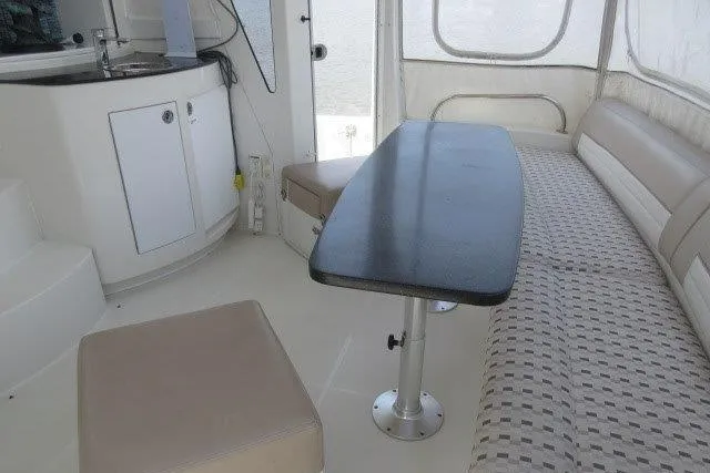  Yacht Photos Pics Interior of 2008 Carver 47 Motor Yacht with seating, table, and kitchenette.