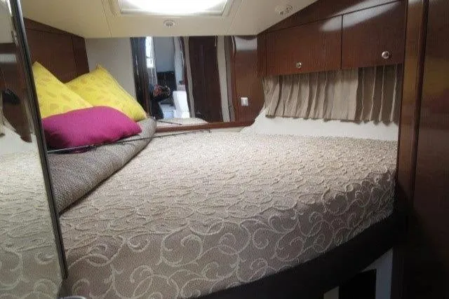  Yacht Photos Pics Interior cabin of 2008 Carver 47 Motor Yacht with cozy bed and wooden cabinetry.