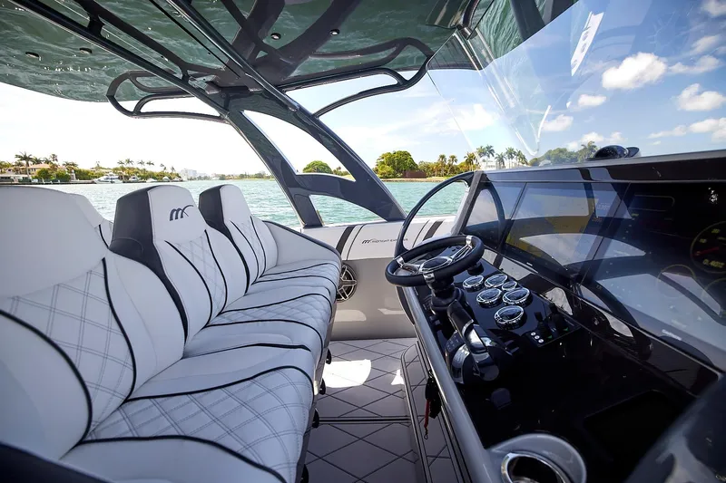 Devenzo Yacht Photos Pics Luxurious interior of 2022 Midnight Express 43 Open boat with modern dashboard and seating.