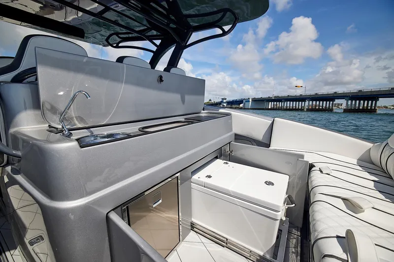 Devenzo Yacht Photos Pics Luxurious 2022 Midnight Express 43 Open yacht interior with sleek kitchenette and seating.