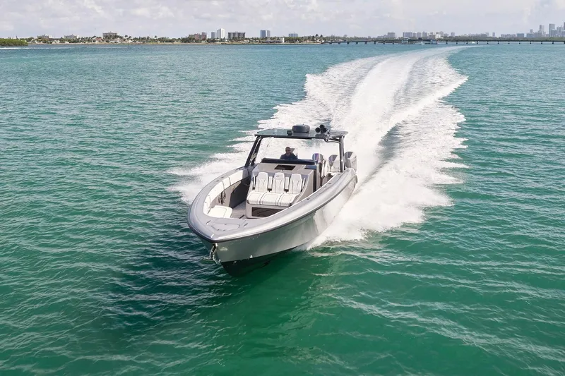 Devenzo Yacht Photos Pics 2022 Midnight Express 43 Open boat cruising on clear turquoise waters.