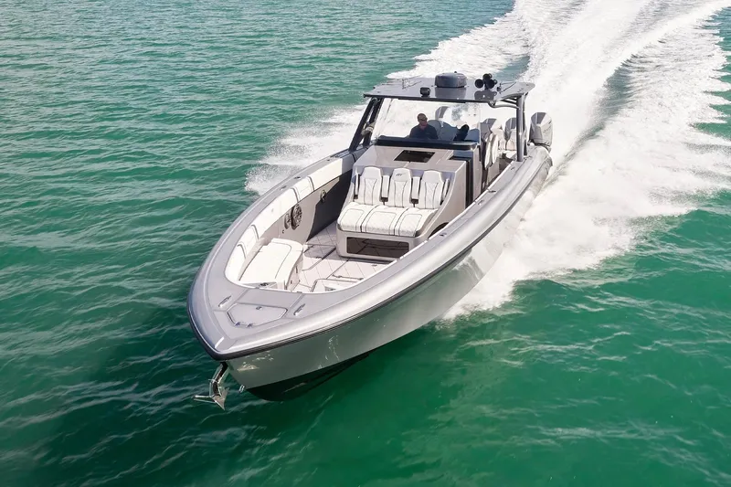 Devenzo Yacht Photos Pics 2022 Midnight Express 43 Open boat cruising on clear turquoise water.