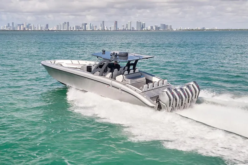Devenzo Yacht Photos Pics 2022 Midnight Express 43 Open boat cruising on turquoise water with city skyline backdrop.