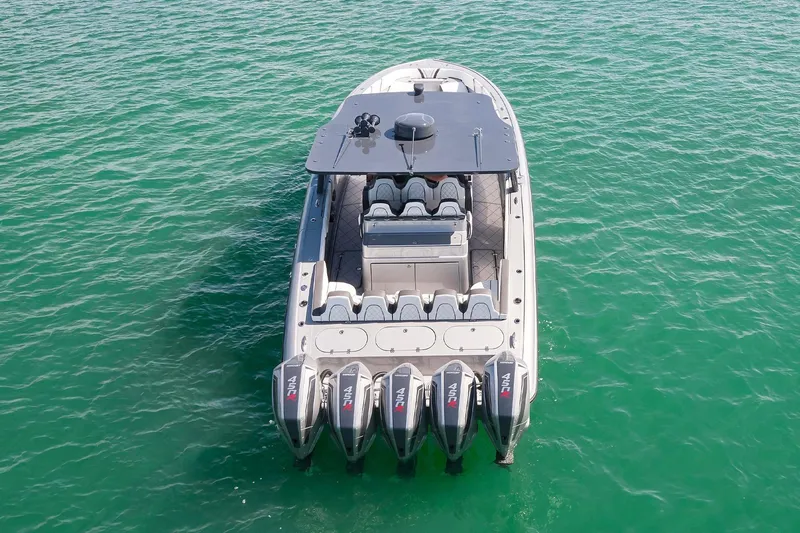 Devenzo Yacht Photos Pics 2022 Midnight Express 43 Open boat with five powerful outboard engines on turquoise water.