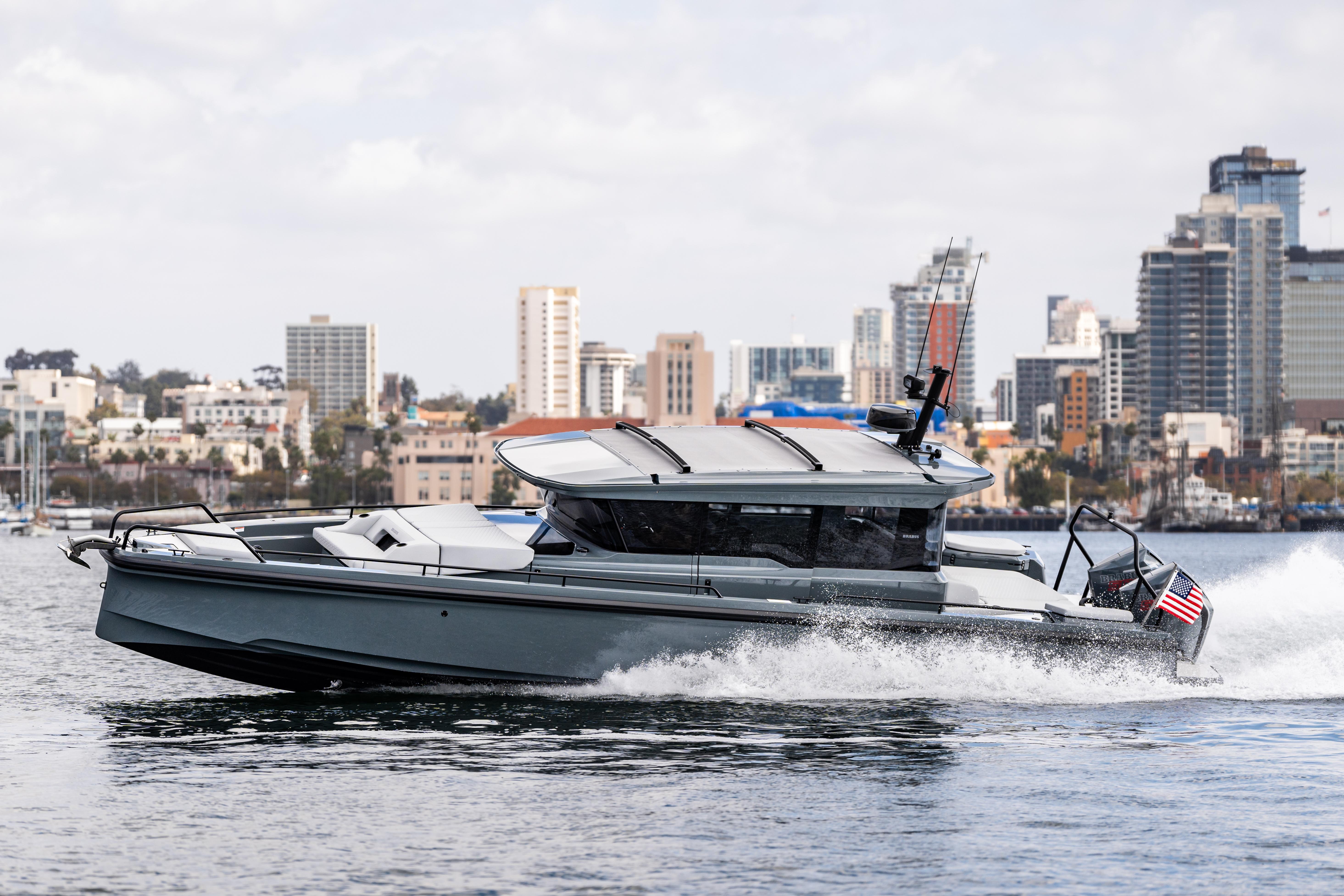 2025 BRABUS 1000 Cross Cabin Signature Edition yacht cruising near city skyline.