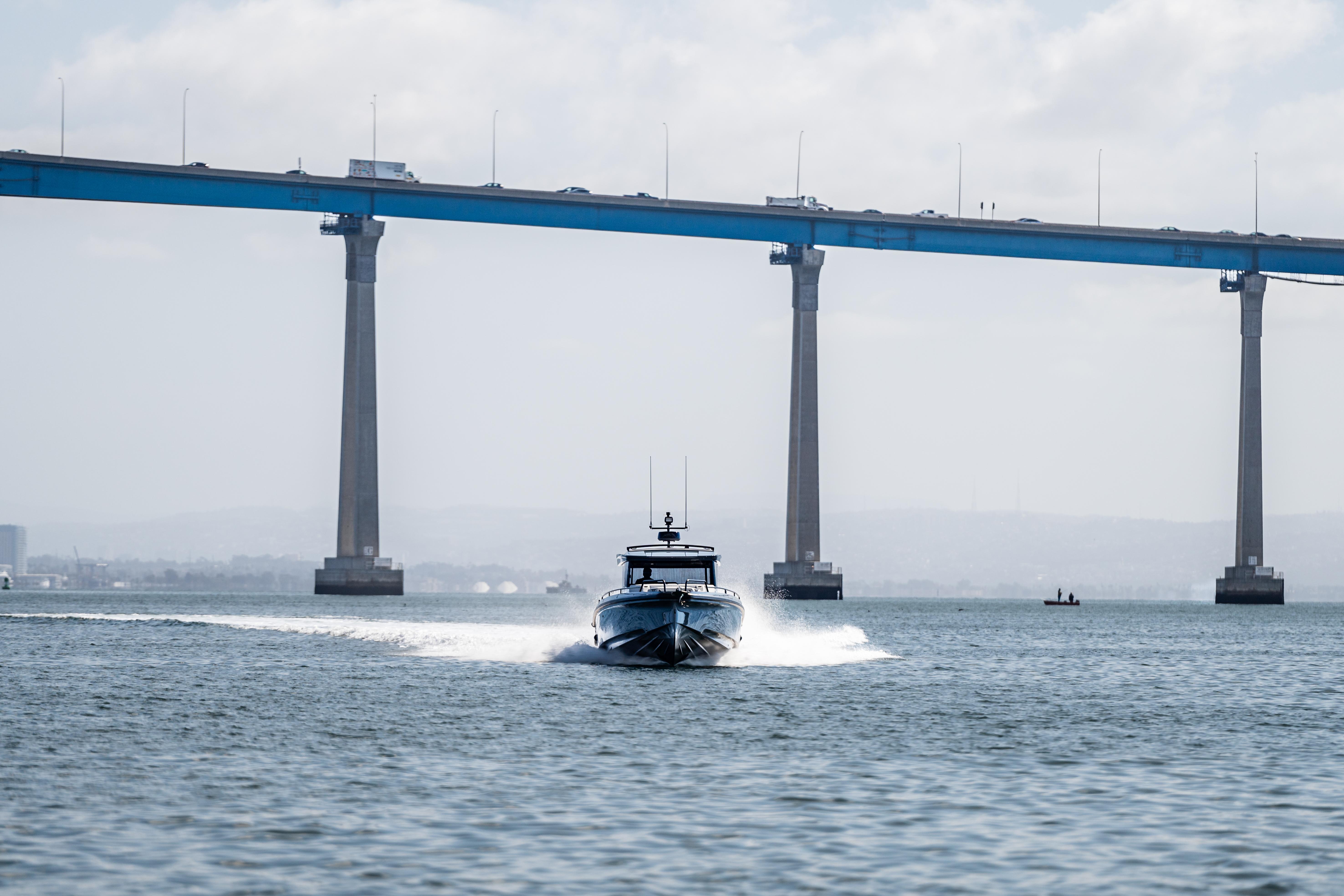 2025 BRABUS 1000 Cross Cabin Signature Edition yacht cruising under a large bridge.
