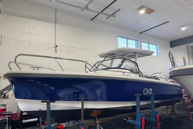  Yacht Photos Pics 2025 Nimbus Tender 8 boat in a garage, blue hull, labeled "Chill."