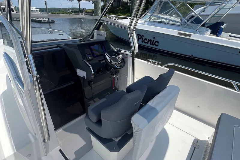  Yacht Photos Pics Interior view of 2025 Nimbus Tender 8 boat with modern helm and seating.