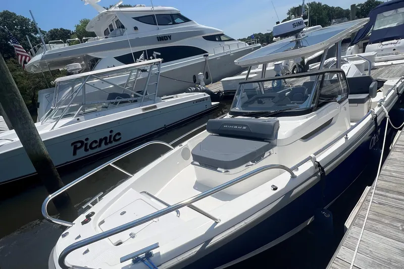  Yacht Photos Pics 2025 Nimbus Tender 8 boat docked alongside other vessels in a marina.