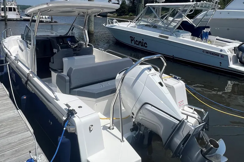  Yacht Photos Pics 2025 Nimbus Tender 8 boat docked, featuring sleek design and modern outboard motor.